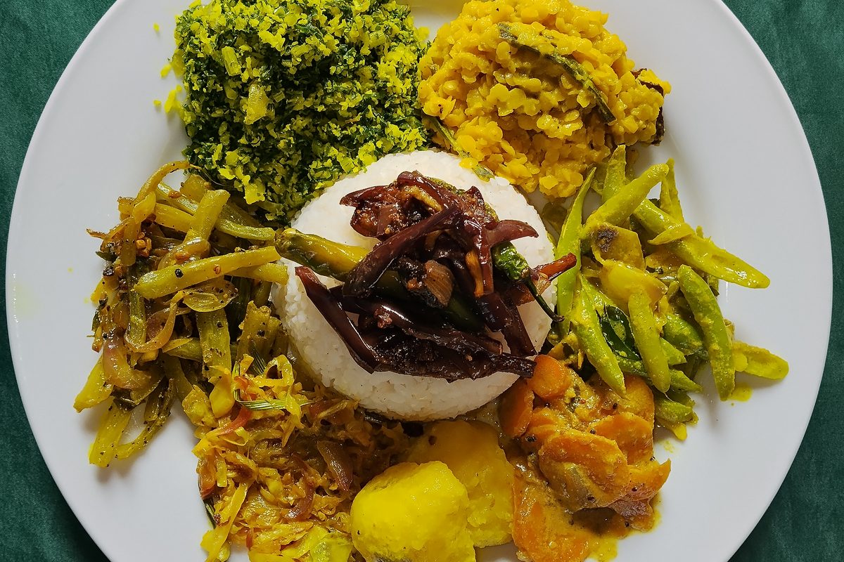 Sri Lankan rice and curry plate with dhal, gotu kola sambol, green bean and jackfruit curries served in Nilaveli