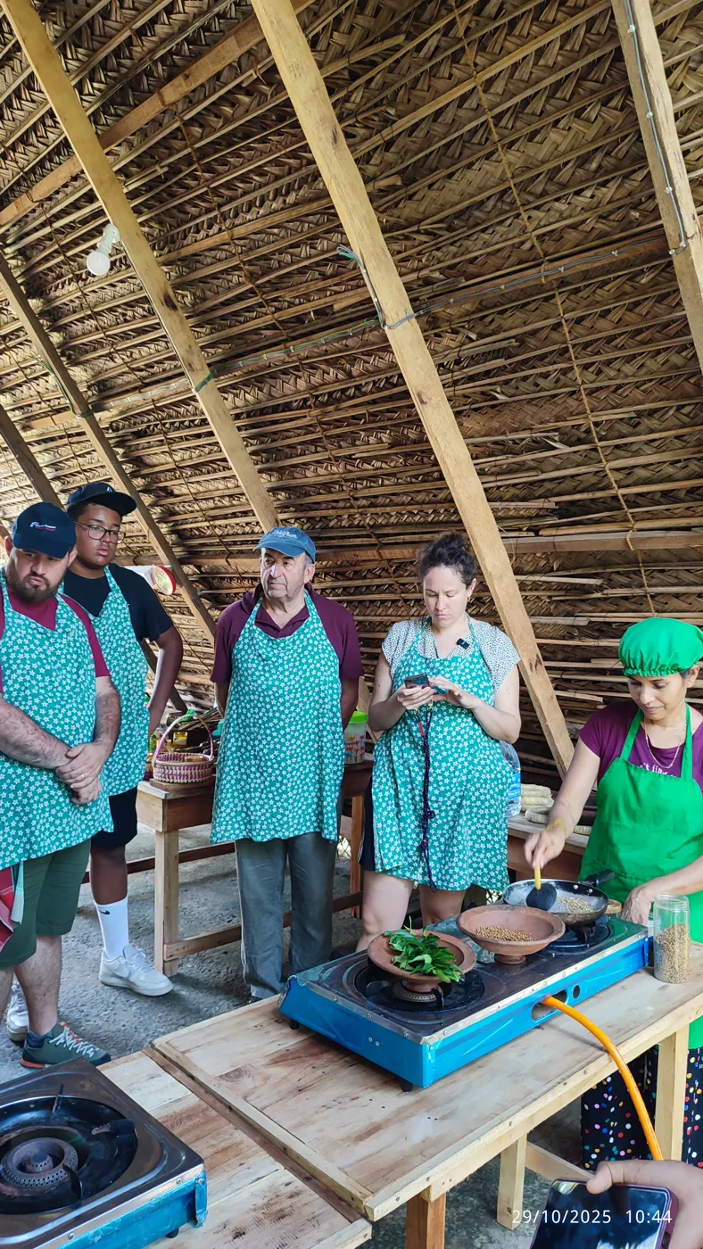 Small group cooking class watching a Sri Lankan spice roasting demonstration in a traditional kitchen