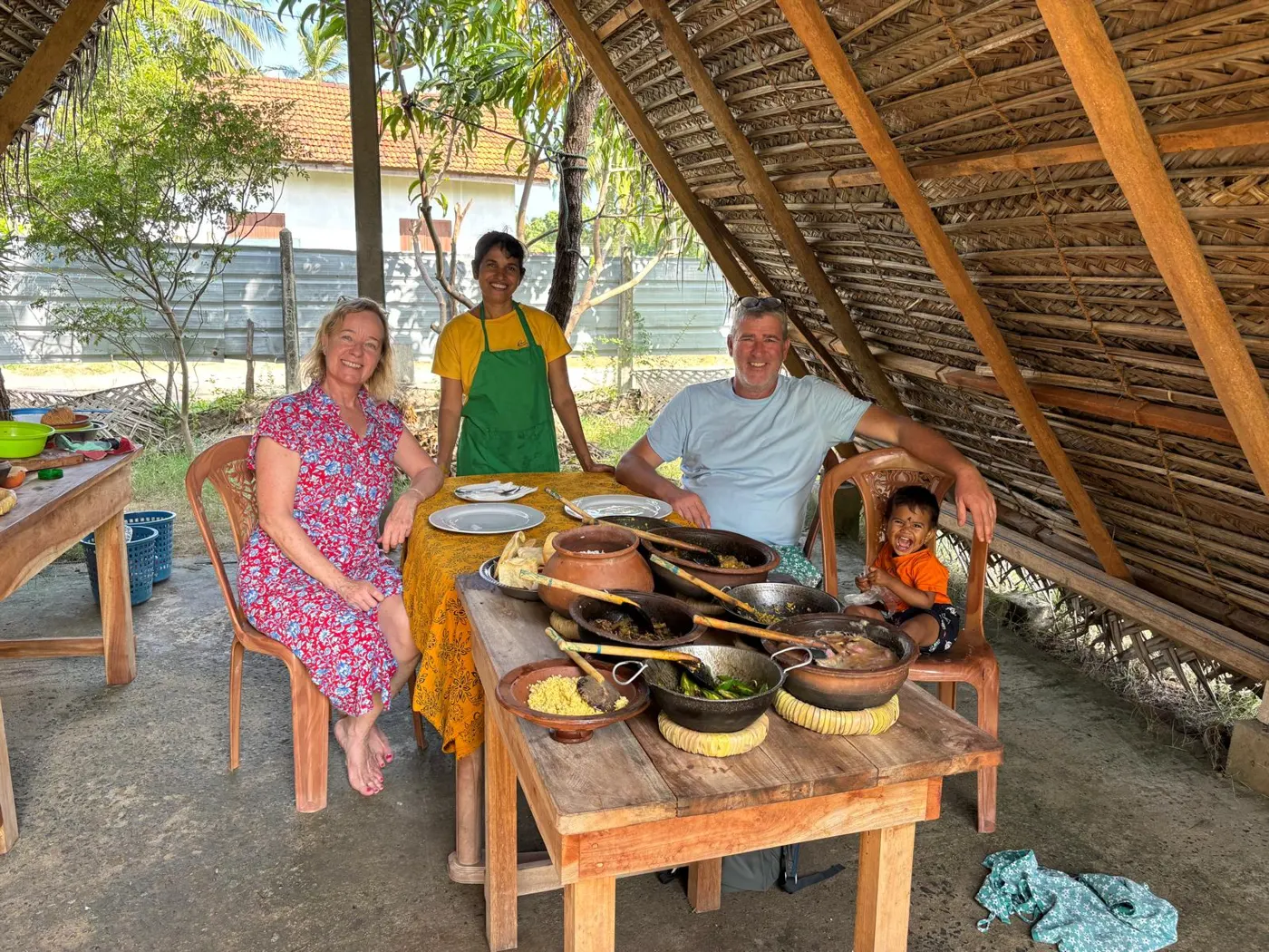 Guests and Nimali enjoying the dining experience with clay pot curries at the Nilaveli cooking class