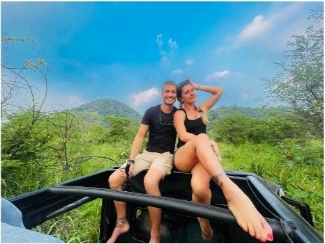 Two safari guests sitting on the open roof of a Pigeon Island Tours jeep
