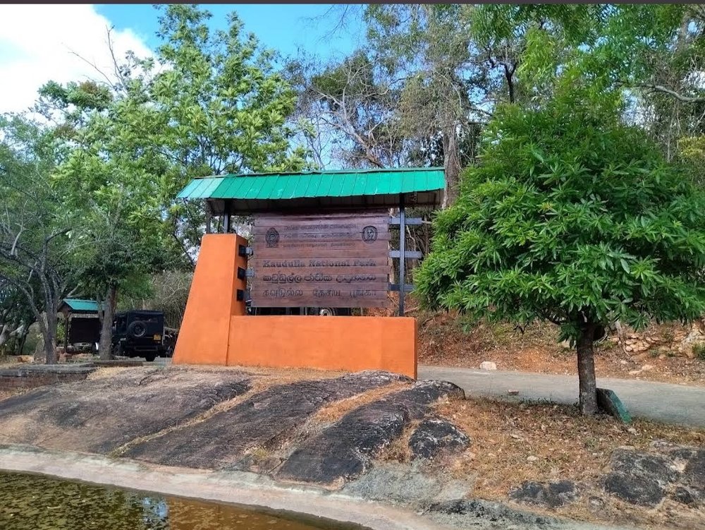 The Kaudulla National Park entrance sign, where the combo safari begins