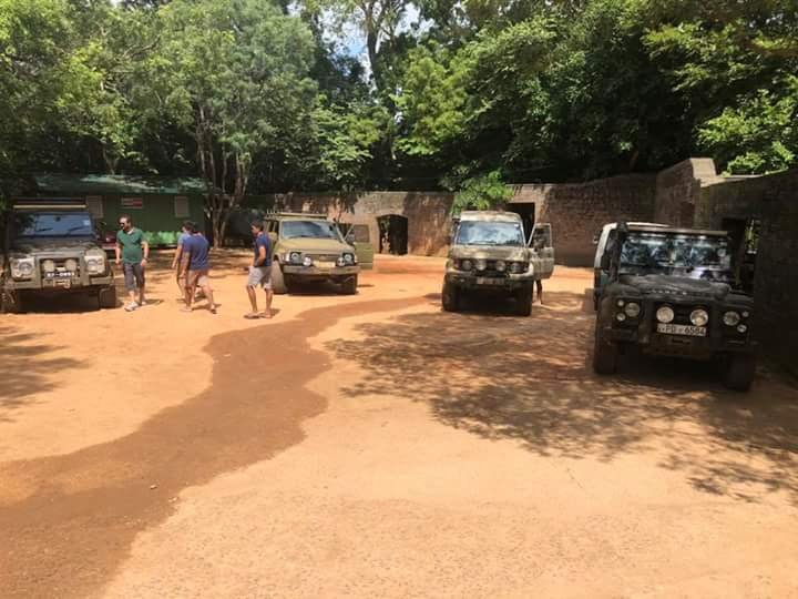 Safari jeeps parked at the Kaudulla park office while permits are issued