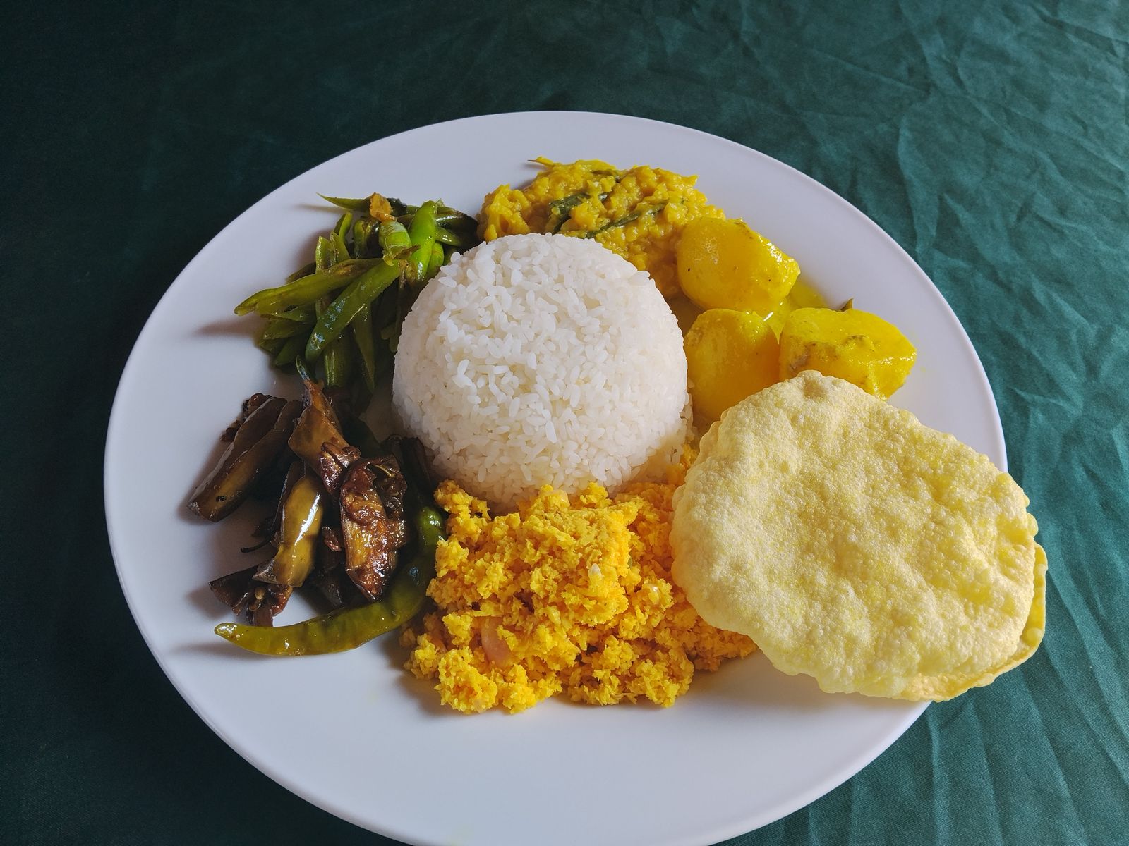 Vegetarian rice and curry with dhal, potato curry, green beans, brinjal and papadam