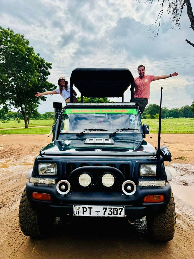 Two guests standing up through the roof of a Pigeon Island Tours safari jeep at Udawalawe